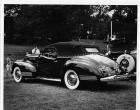 1942 Packard convertible victoria, three-quarter rear view, top raised, parked on grass