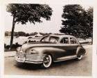 1946 Packard Clipper sedan parked on Belle Isle, Scott fountain in distance