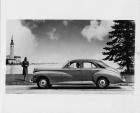 1946 Packard Clipper touring sedan, parked on street, female behind wheel