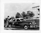 1946 Packard taxicab, parked on street, couple getting in rear passenger door