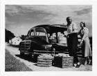 1948 Packard station sedan, two women loading bushels of vegetables into back