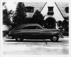 1948 Packard club sedan, right side view, parked on street in front of house