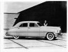 1949 Packard sedan, female holding a small dog standing near driver's door
