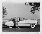 1949 Packard sedan, parked on grass, pier with boats in background