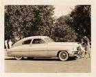 1949 Packard club sedan, parked on grass, couple with golf club at front of car