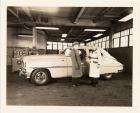 1950 Packard sedan, left side view, Mike Kollins & T.W. Nerthey standing at driver's door