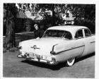 1951 Packard 300, parked on grass, female standing at left side of trunk
