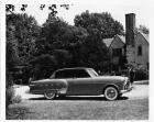 1952 Packard Patrician 400 parked in driveway near house, couple in background