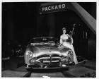 1952 Packard Pan American sports car, female standing at driver's side holding large trophy
