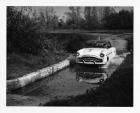 1952 Packard Mayfair sport coupe passing through large puddle