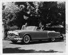 1953 Packard Pan American convertible, three-quarter left side view, parked in driveway, female behi