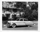 1953 Packard touring sedan, nine-tenths left side view, parked on street in front of house