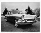 1957 Packard station wagon, female standing at driver's door