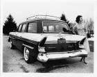 1957 Packard station wagon, rear view, female standing at passenger side