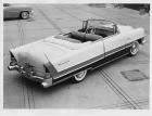 1955 Packard convertible, three-quarter rear right elevation view, top folded, parked in driveway
