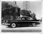 1958 Packard sedan, parked in driveway, house in background